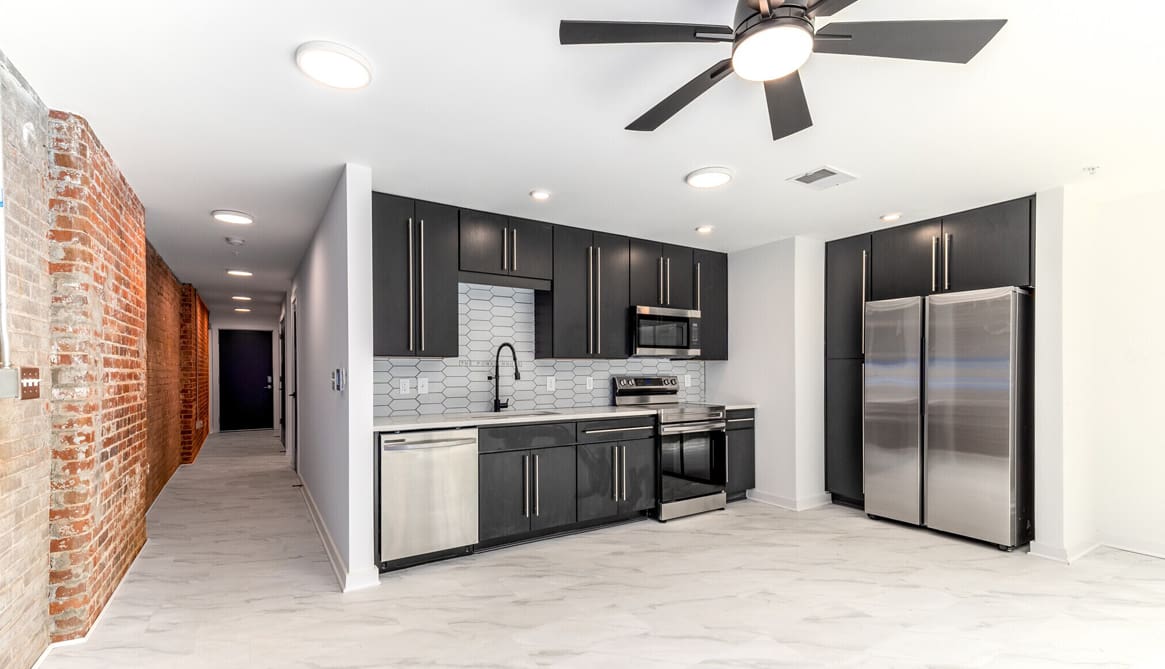 LP-Power-House-Rock-Hill-kitchen-black-cabinets-brick-wall